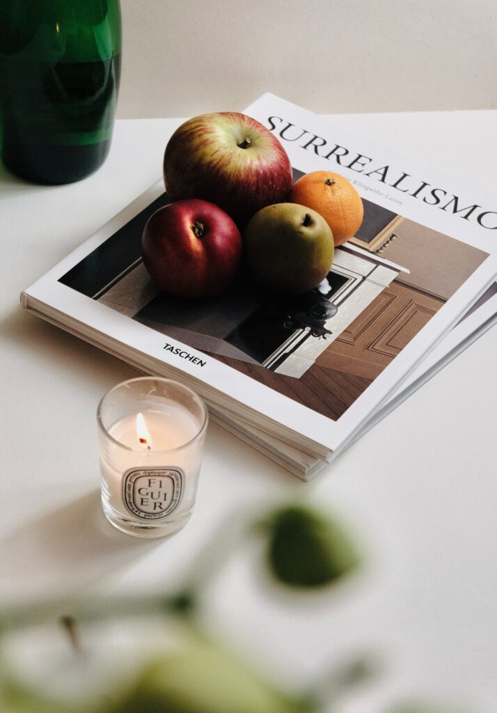 red and green apples beside clear drinking glass